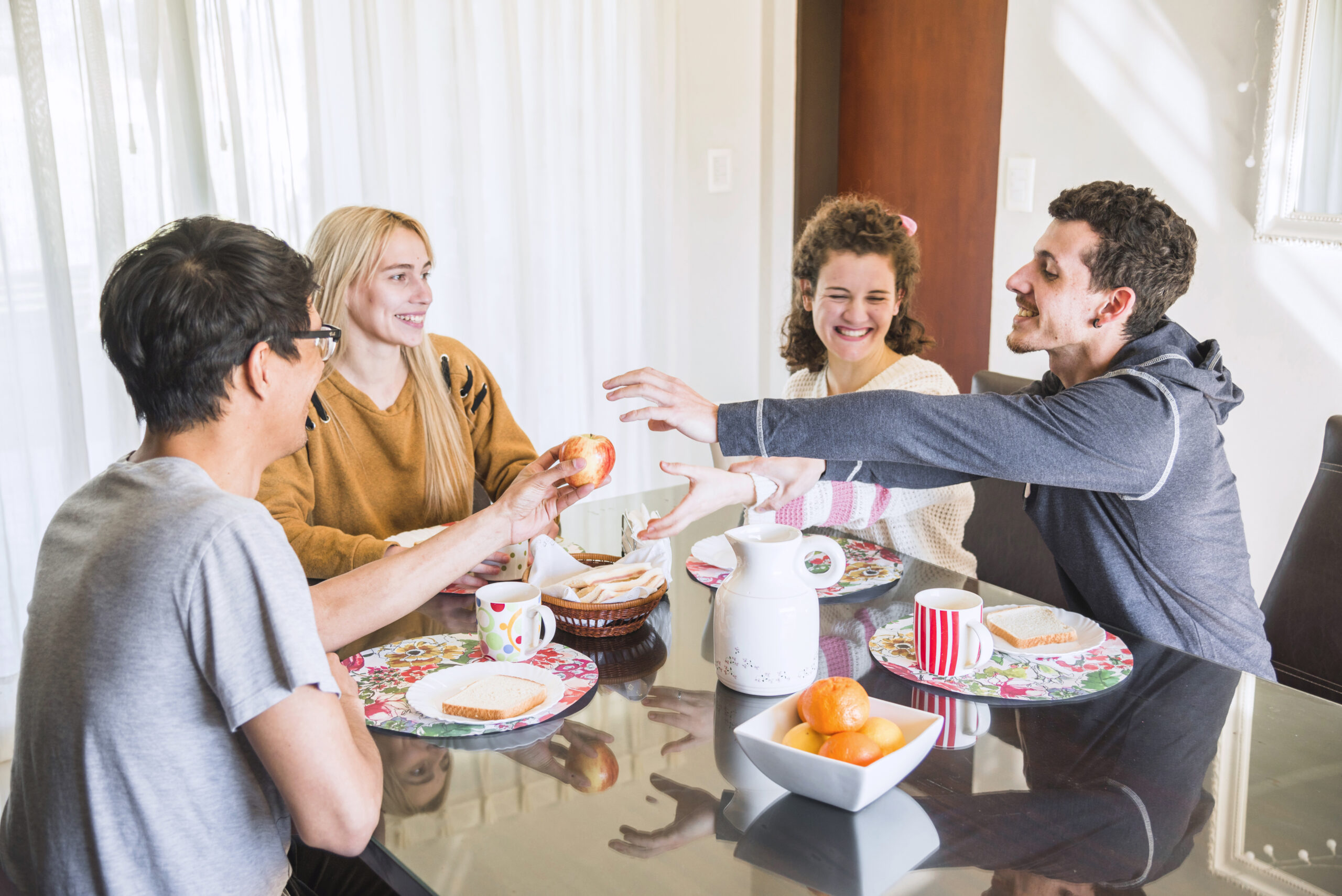 friends-trying-get-apple-from-man-s-hand-breakfast